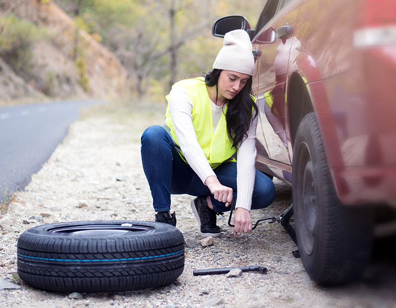 Woman changing a tire