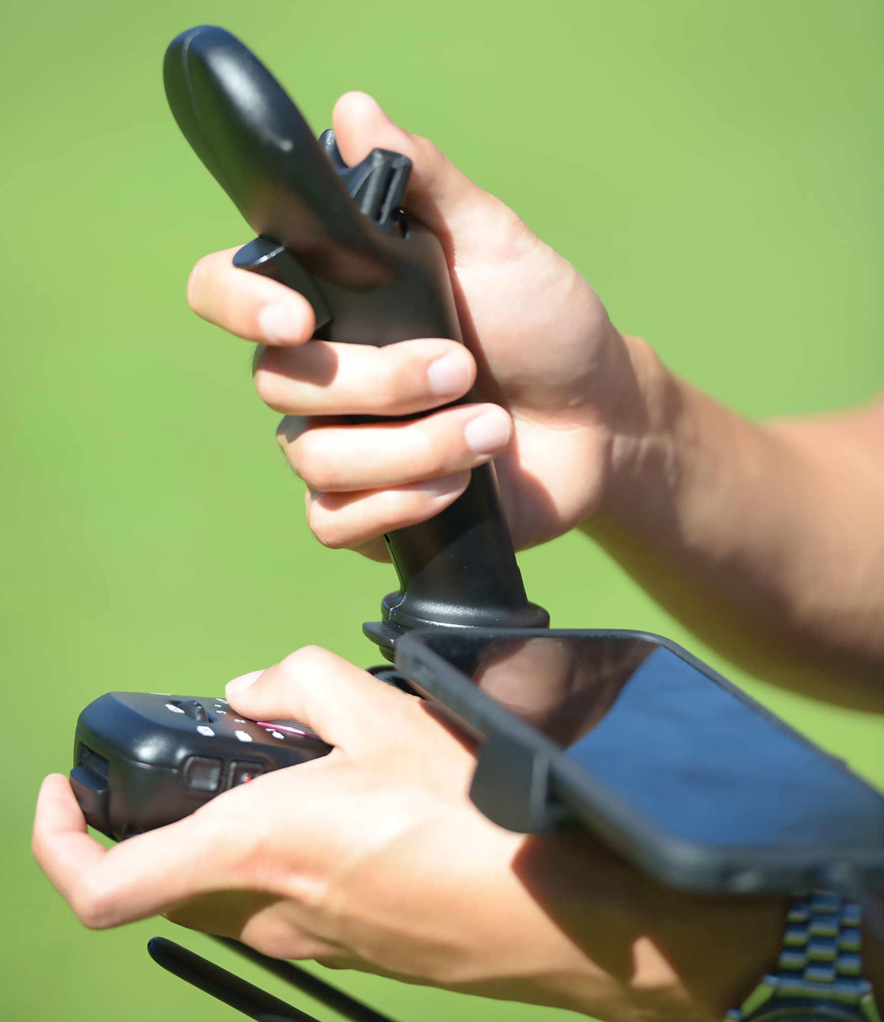 Closeup of hands manipulating the FT Aviator controller