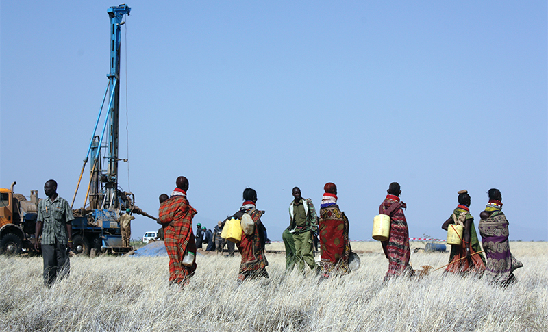 People watching water pumps