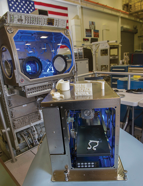 The prototype 3D printer for microgravity with samples of products