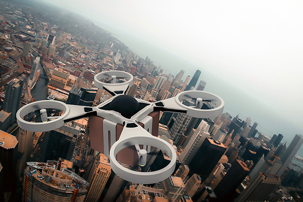 A quadcopter drone carrying a cardboard box over a city