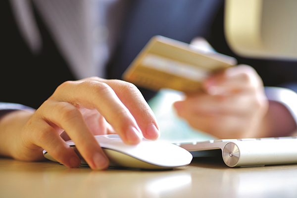 Woman with credit card and computer mouse