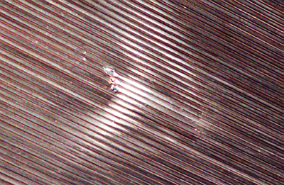 Close-up view of three small holes in the liquid hydrogen tubes of the Shuttle