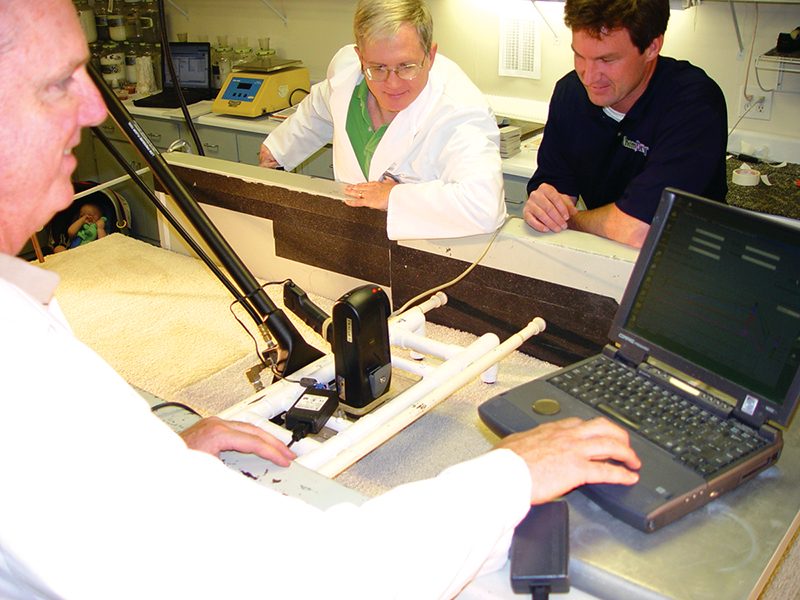 A scanner hooked up to a vacuum cleaner performs carpet cleaning tests