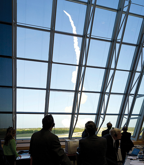 NASA staff watching space shuttle launch