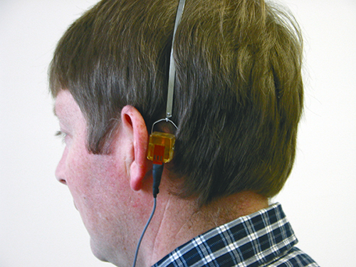 A man wearing hearing test equipment