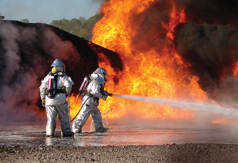 Firefighters using fire suppression system