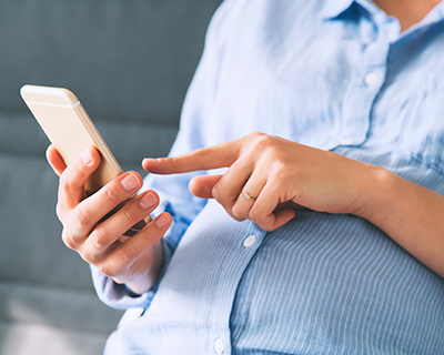 Pregnant woman using cell phone