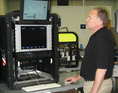 A Deep Ocean Engineering scientist operates the underwater system