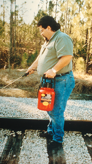 Sun Coast Chemical's Chris Fornili sprays railroad tracks with a special lubricant 