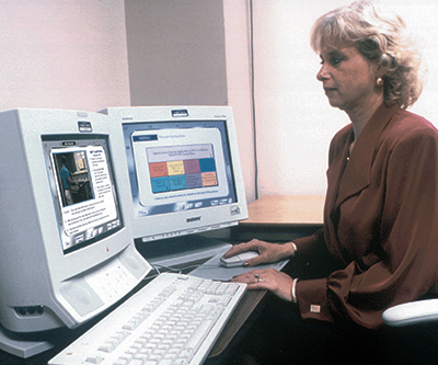 A woman undergoes on-the-job training on a computer