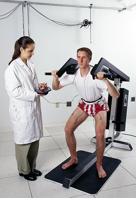 Man using the Delsys system with woman monitoring