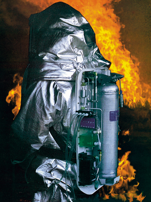 A person surrounded by flames wearing SCAMP, a self-contained breathing apparatus