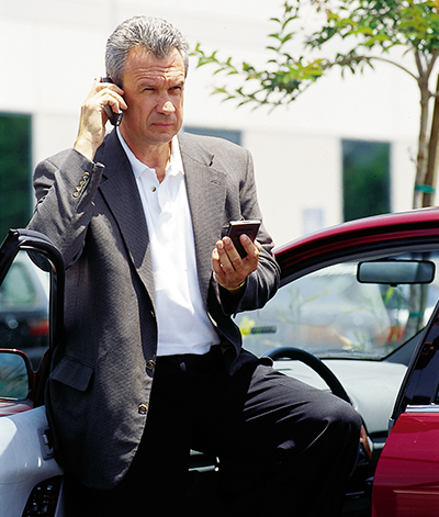 A man using the web time-management tool from his parked car