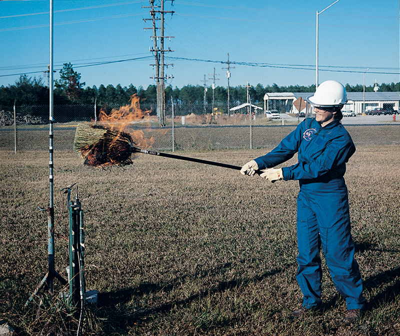 NASA engineer Heidi Barnes demonstrates the antiquated "broom method" of detecting invisible hydrogen and alcohol fires