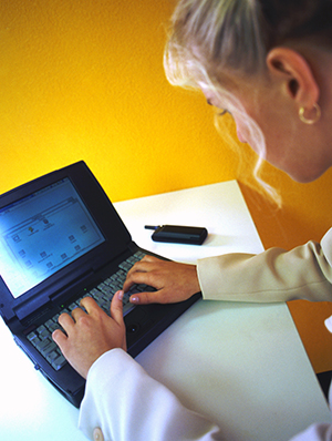 A nurse uses Home Care Connect with a laptop and the Internet