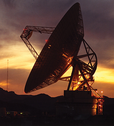 Large satellite dish at sunset