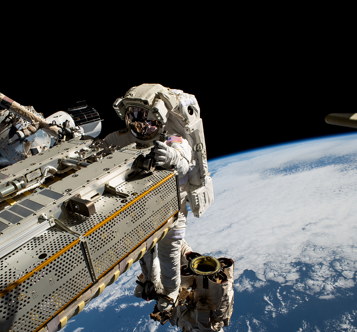 NASA astronaut and Expedition 68 Flight Engineer Woody Hoburg rides the Canadarm2 robotic arm