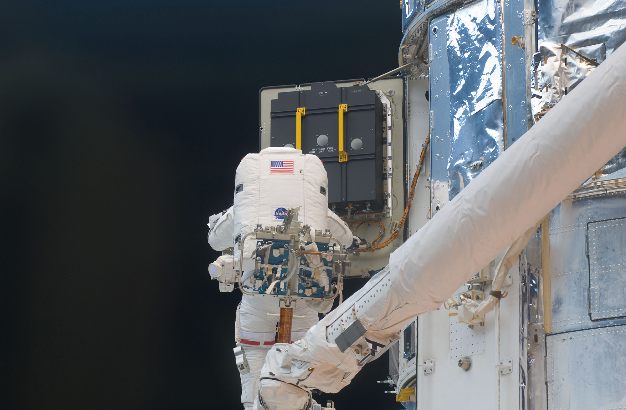 Astronaut John Grunsfeld replaces the Hubble Space Telescope’s original nickel-hydrogen batteries in 2009