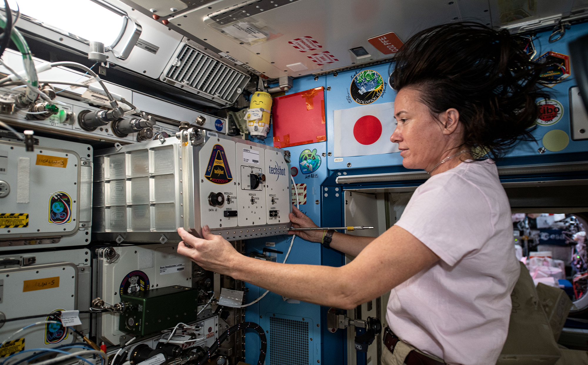 NASA astronaut Megan McArthur installs a new ADSEP experiment locker on the International Space Station in this photo from 2021