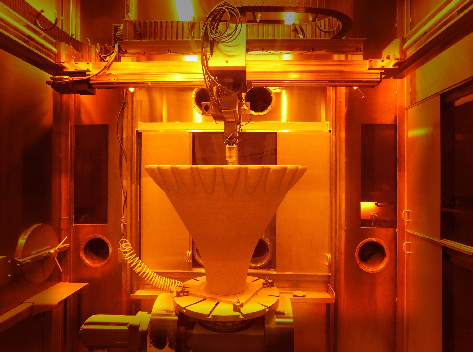 A laser powder directed energy deposition (LP-DED) 3D printer at RPM Innovations’ facility additively manufactures a large-scale aerospike rocket engine nozzle