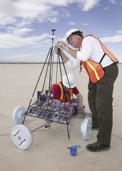 Engineers check a robotic climber before a challenge