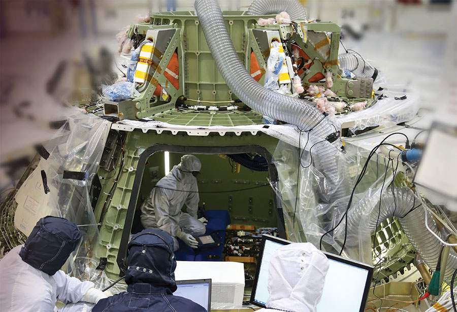 Technicians working on Orion capsule