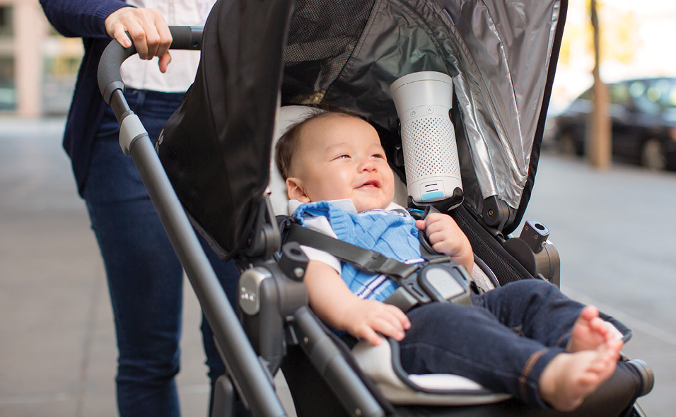 A Wynd air purifier in a stroller with a baby