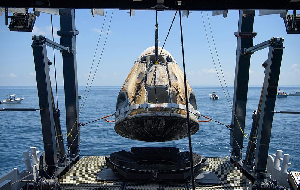 The scorched SpaceX Crew Dragon Endeavour capsule is lifted out of the Gulf of Mexico
