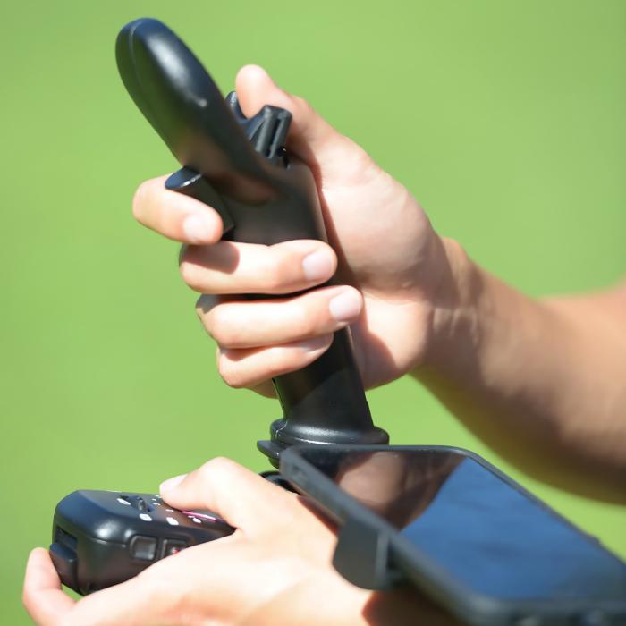 Closeup of hands manipulating the FT Aviator controller