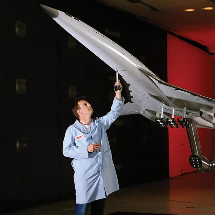 NASA engineer with model of High-Speed Civil Transport aircraft