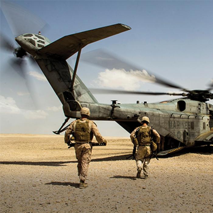 Soldiers run toward helicopter