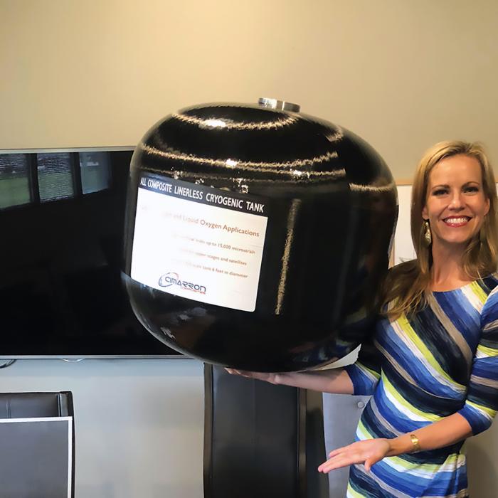 Woman holds large composite overwrapped pressure vessel easily in one hand