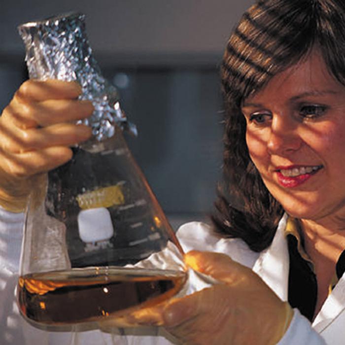 Woman with beaker of liquid