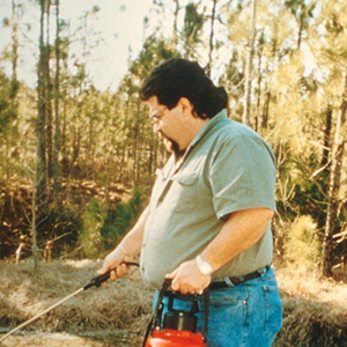 Sun Coast Chemical's Chris Fornili sprays railroad tracks with a special lubricant 