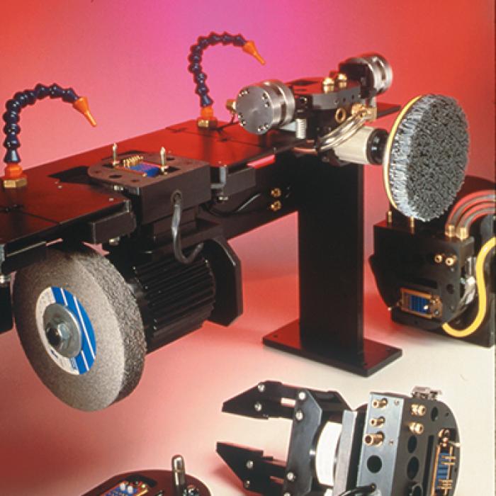 The tool rack of the Automatic Robotics Tool-change System includes a two-finger gripper, a grinder, a coated abrasive brush and a welding torch