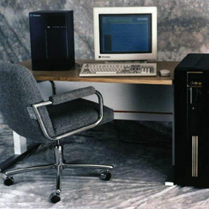 A computer simulation processor pictured against a smaller computer workstation to show scale