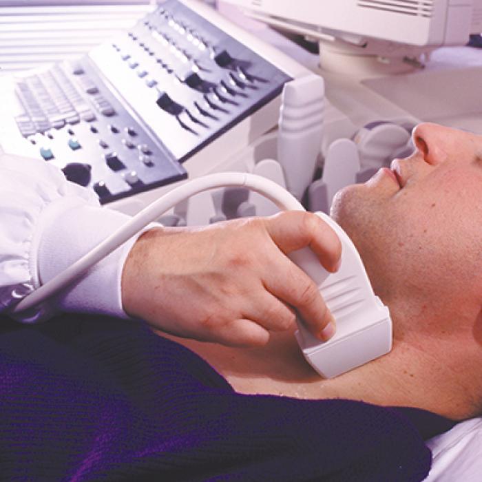 A patient getting an ultrasound of his neck