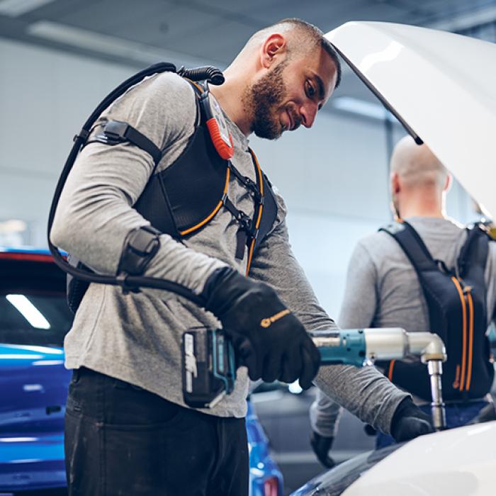 Swedish company Bioservo Technologies’ Ironhand robotic glove being used with a power tool under a car hood