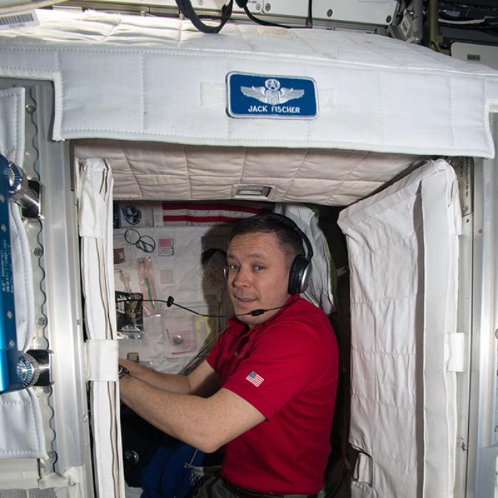 An astronaut in his sleeping cabin