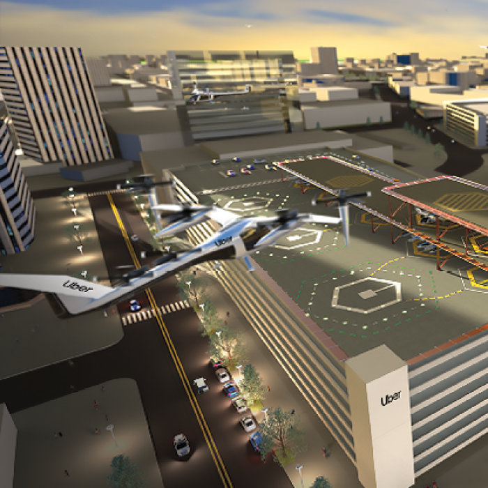 Rendering of urban air taxi rooftop landing zone, with several air taxis in flight