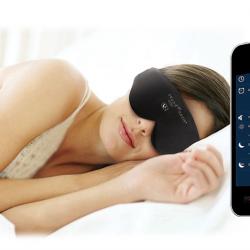 A woman lies in bed wearing the Illumy sleep mask. A smartphone shows the Illumy app interface.