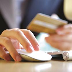 Woman with credit card and computer mouse