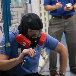 Two men wearing emergency breathing devices