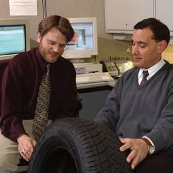 NASA's Dr. Steven Arnold (left) and Goodyear Tire & Rubber Co.'s Dr. Mahmoud Assaad inspect a MAC-manufactured tire