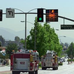 Emergency vehicles crossing intersection with LED displays above