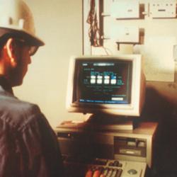 A plant technician checks an industrial process stream on a monitor