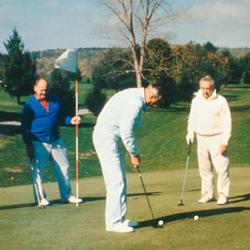 Four men playing golf on a golf course