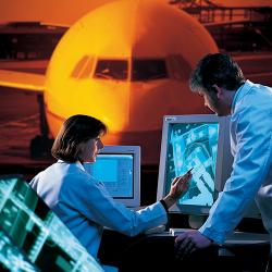 A man and a woman view radiography on computers with an image of a plane behind them