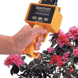 The Observer hand-held device pointed at a flowering shrub